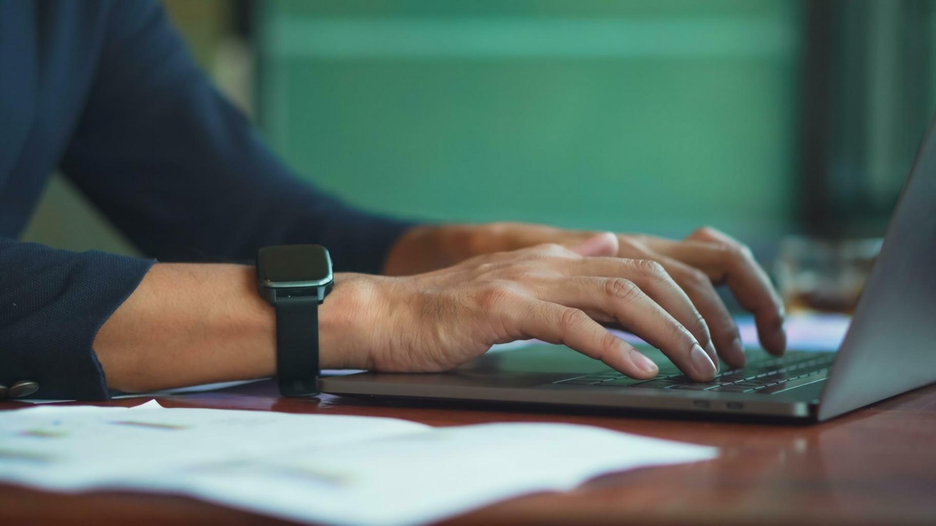 Person reviewing budget planning materials and financial documents